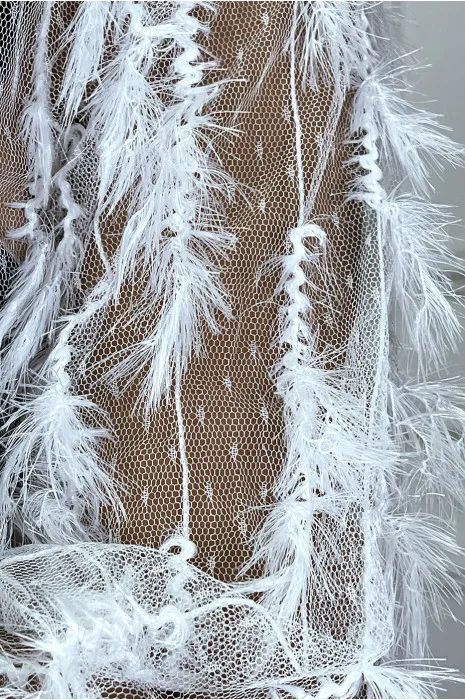 White mesh embroidered top with turtleneck and ribbed sleeves.